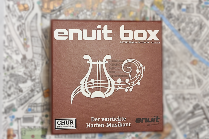 Enuit Box  Brown box with "enuit box" and musical symbols, including a harp and notes